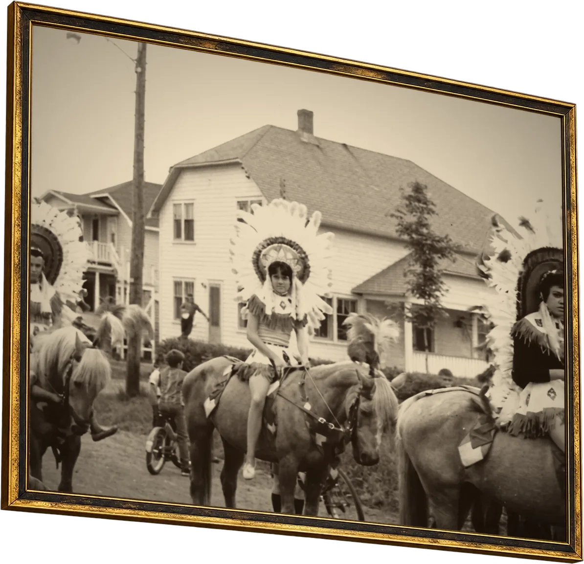 Garden Bros Circus in the 1930s: young riders in feathered headdresses on horseback in front of a white house